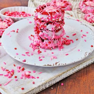 pink decorated cookies sitting on plate