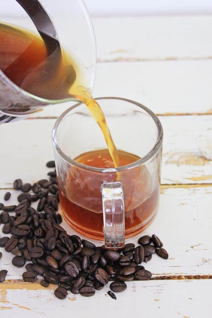 coffee pouring into mug on table