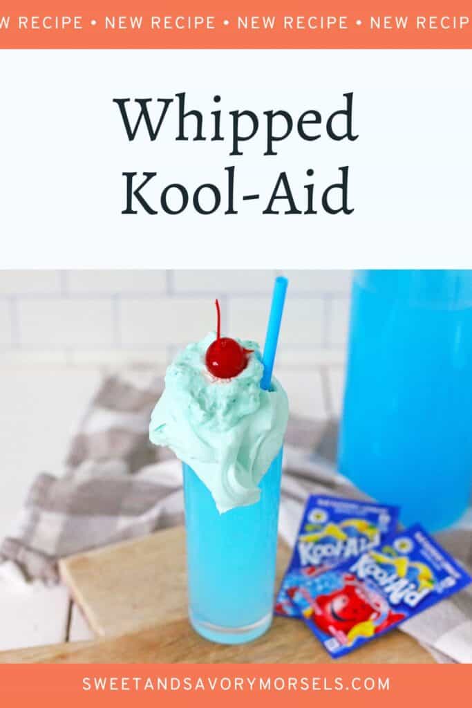 A tall glass of blue Whipped Kool-Aid topped with a cherry and a light blue straw, surrounded by Whipped Drink packets and a blue pitcher.